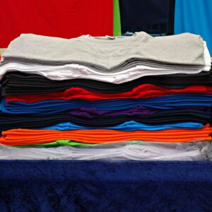 t-shirt, tee, clothing, garment, shirt, fashion, unisex, woman, man, top, casual, pile, pile of t-shirts, market, stall, market stall, t-shirt, t-shirt, t-shirt, t-shirt, t-shirt, shirt, shirt, shirt